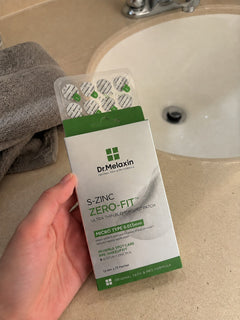 Zero-Fit pack held over a bathroom counter