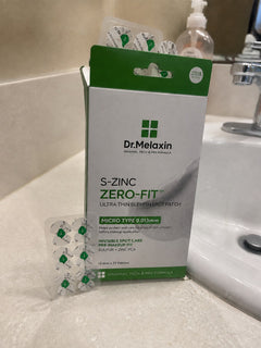 Zero-Fit pack and patch sheet resting beside a sink