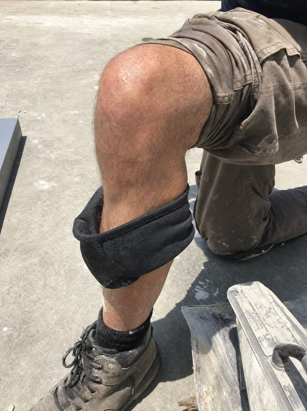 Strap-on knee pad twisted sideways and slid down